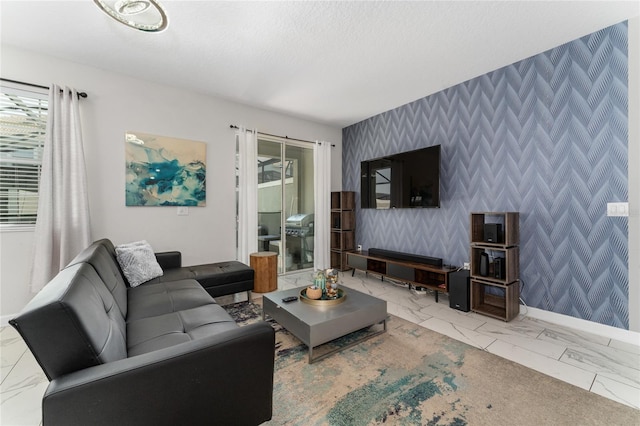 4974 Windermere Ave, Kissimmee, FL 34746 - living area featuring wallpapered walls, an accent wall, and marble finish floors