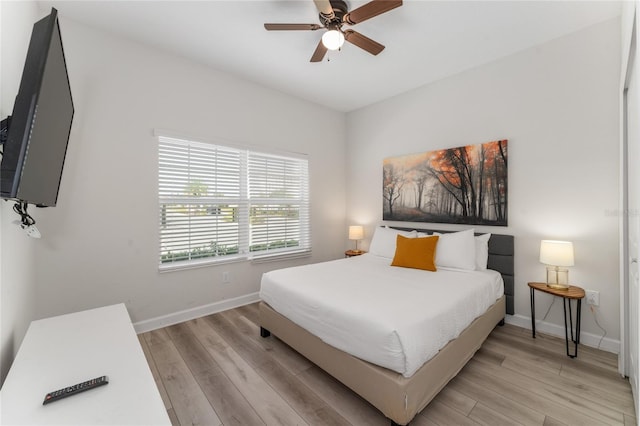 4974 Windermere Ave, Kissimmee, FL 34746 - bedroom with light wood finished floors and ceiling fan