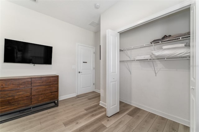 4974 Windermere Ave, Kissimmee, FL 34746 - unfurnished bedroom featuring light wood finished floors and a closet