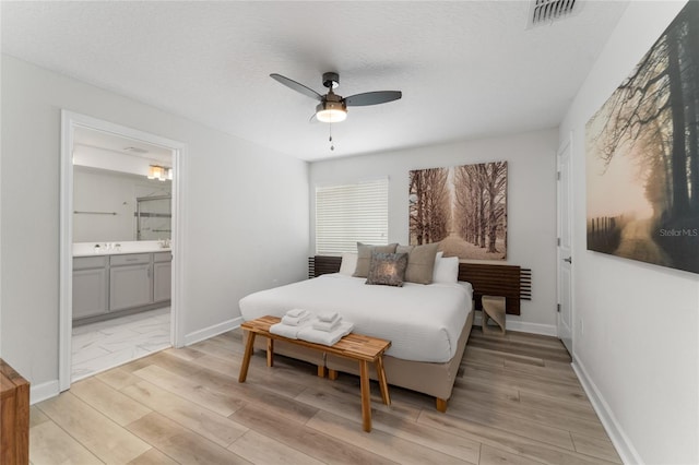 4974 Windermere Ave, Kissimmee, FL 34746 - bedroom with light wood-type flooring, ensuite bathroom, and ceiling fan