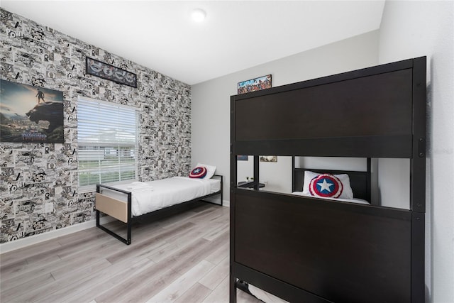 4974 Windermere Ave, Kissimmee, FL 34746 - bedroom with an accent wall, light wood-type flooring, and wallpapered walls