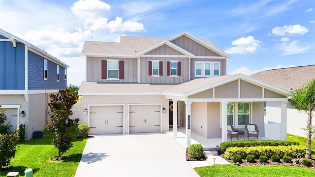 13993 Title Way, Winter Garden, FL 34787 - view of front of home with covered porch, an attached garage, concrete driveway, board and batten siding, and roof with shingles