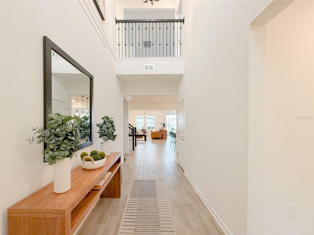 13993 Title Way, Winter Garden, FL 34787 - hall with a chandelier, light wood-type flooring, and a high ceiling