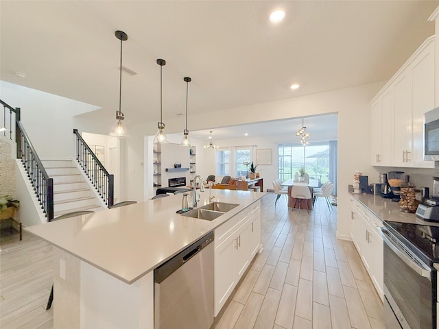 13993 Title Way, Winter Garden, FL 34787 - kitchen with appliances with stainless steel finishes, open floor plan, white cabinetry, light countertops, and recessed lighting