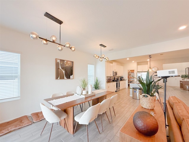 13993 Title Way, Winter Garden, FL 34787 - dining room featuring light wood-style floors and a chandelier
