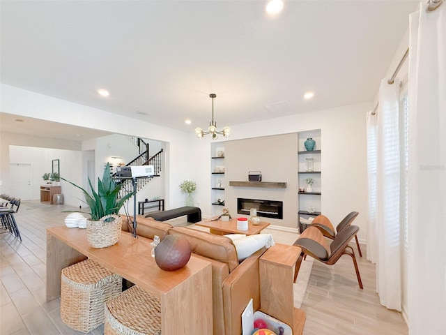 13993 Title Way, Winter Garden, FL 34787 - living area featuring a chandelier, recessed lighting, built in features, and a glass covered fireplace
