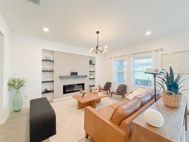 13993 Title Way, Winter Garden, FL 34787 - living room featuring a glass covered fireplace, built in features, a chandelier, and recessed lighting