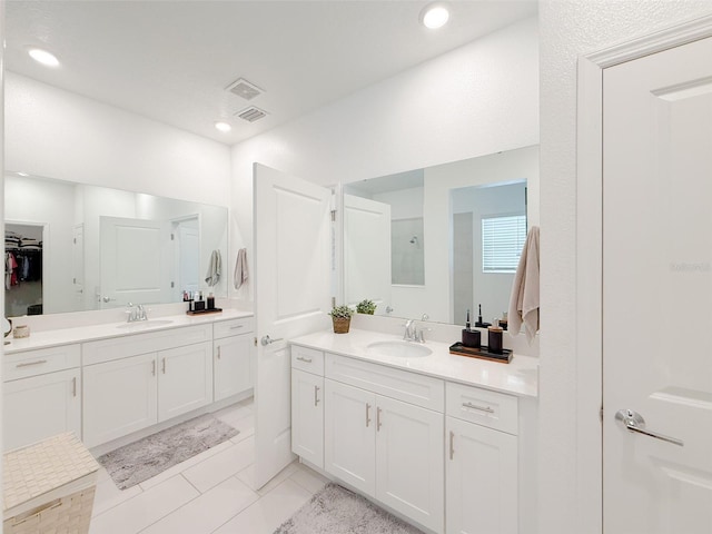 13993 Title Way, Winter Garden, FL 34787 - bathroom featuring two vanities, tile patterned flooring, and recessed lighting