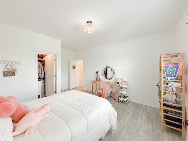 13993 Title Way, Winter Garden, FL 34787 - bedroom featuring light wood-type flooring, a spacious closet, and a closet