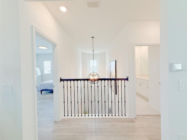 13993 Title Way, Winter Garden, FL 34787 - hall featuring light wood finished floors, healthy amount of natural light, and a chandelier
