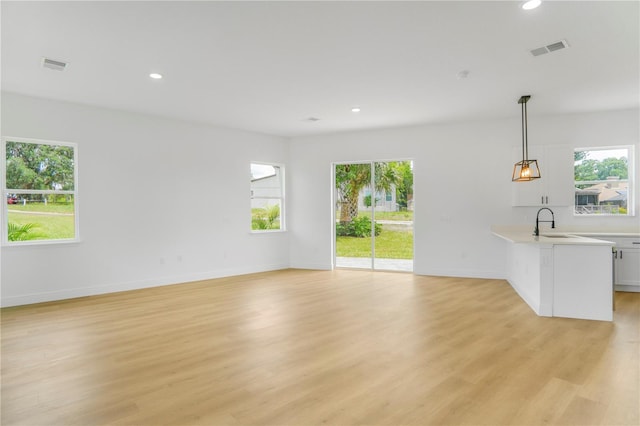 1006 Linkside Ct, Apopka, FL 32712 - unfurnished living room featuring light wood-type flooring and recessed lighting
