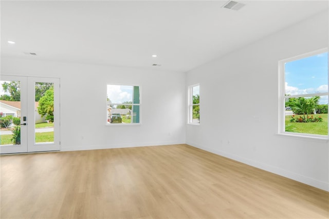 1006 Linkside Ct, Apopka, FL 32712 - empty room with light wood-style floors, french doors, and recessed lighting