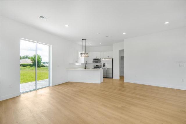 1006 Linkside Ct, Apopka, FL 32712 - unfurnished living room featuring light wood-type flooring and recessed lighting