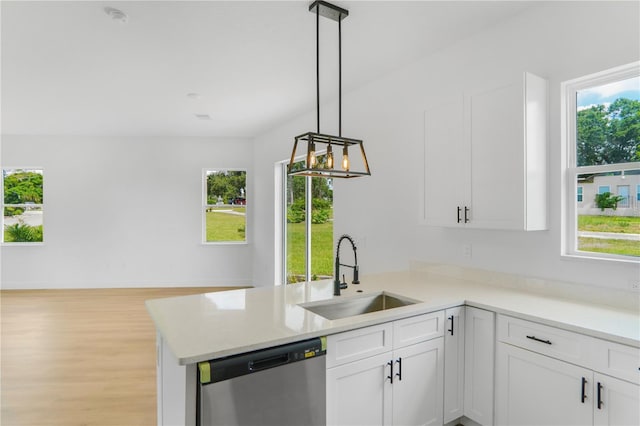 1006 Linkside Ct, Apopka, FL 32712 - kitchen with stainless steel dishwasher, a peninsula, white cabinetry, and light countertops