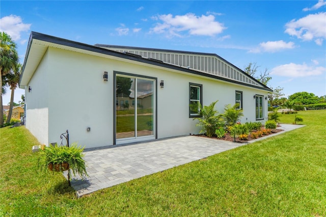 1006 Linkside Ct, Apopka, FL 32712 - back of house featuring stucco siding, a lawn, and a patio