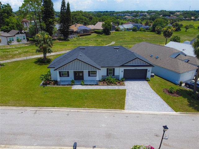 1006 Linkside Ct, Apopka, FL 32712 - view of front of house with an attached garage, decorative driveway, a residential view, and a front lawn