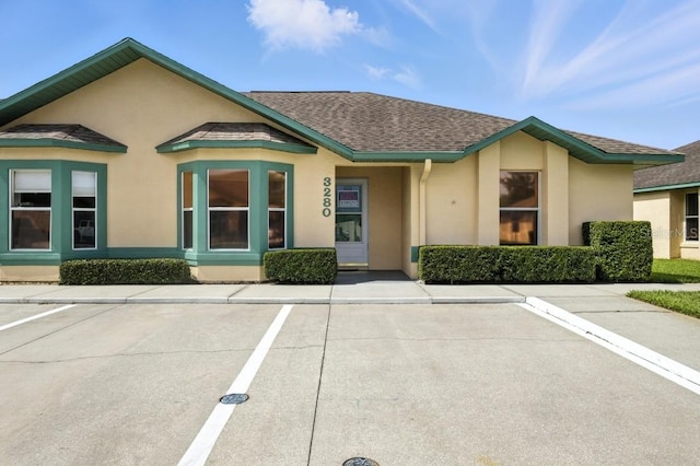 3280 Villa Way Cir, Saint Cloud, FL 34769 - view of front of house with stucco siding, uncovered parking, and a shingled roof