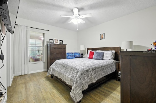 3280 Villa Way Cir, Saint Cloud, FL 34769 - bedroom featuring wood finished floors, a textured ceiling, and a ceiling fan