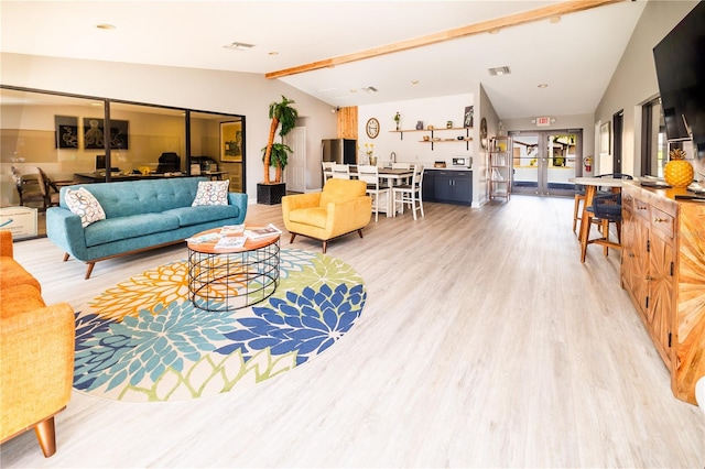 1042 Mollie Ln Unit 81042, Melbourne, FL 32935 - living area featuring vaulted ceiling, french doors, and light wood-style flooring