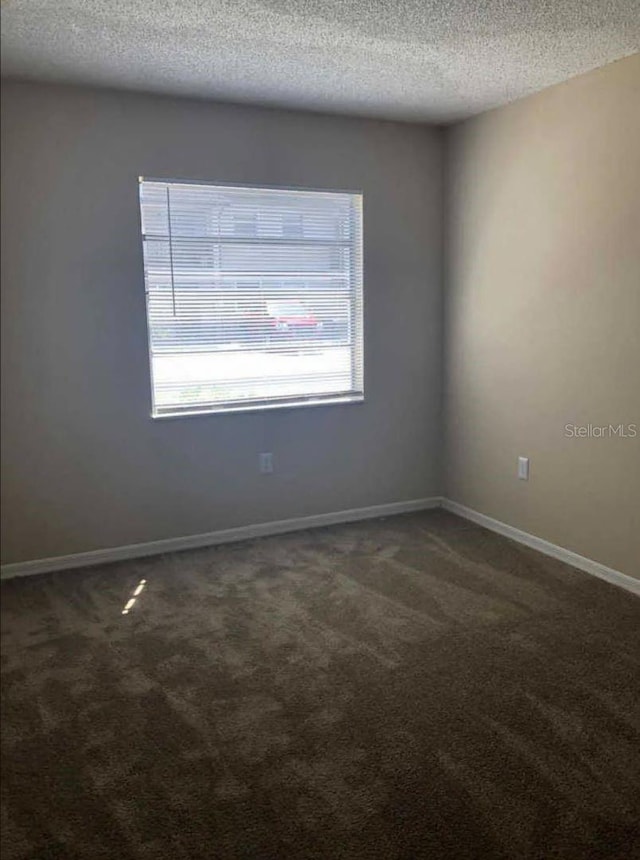 1042 Mollie Ln Unit 81042, Melbourne, FL 32935 - unfurnished room with dark colored carpet and a textured ceiling