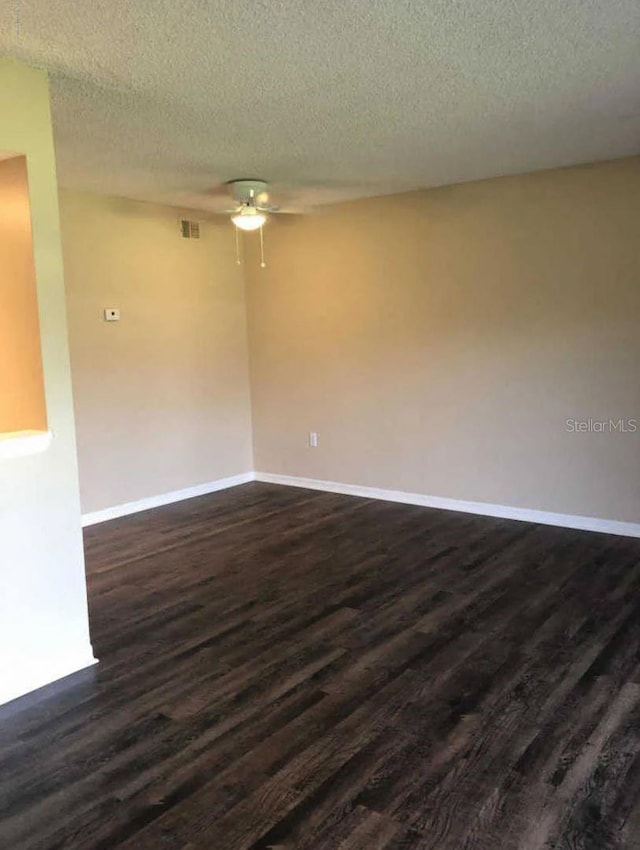 1042 Mollie Ln Unit 81042, Melbourne, FL 32935 - empty room with ceiling fan, dark wood finished floors, and a textured ceiling