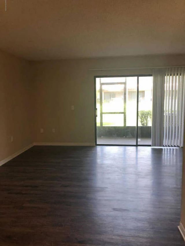 1042 Mollie Ln Unit 81042, Melbourne, FL 32935 - spare room with dark wood-type flooring