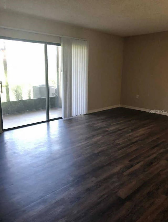 1042 Mollie Ln Unit 81042, Melbourne, FL 32935 - empty room featuring dark wood-style floors and baseboards