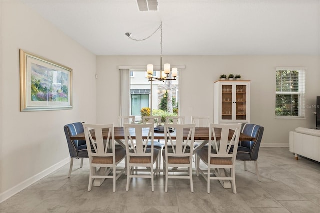 1351 Shinnecock Hills Dr, Davenport, FL 33896 - dining space with a chandelier and baseboards