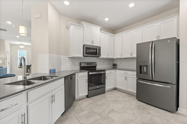 1351 Shinnecock Hills Dr, Davenport, FL 33896 - kitchen featuring appliances with stainless steel finishes, white cabinetry, tasteful backsplash, and recessed lighting