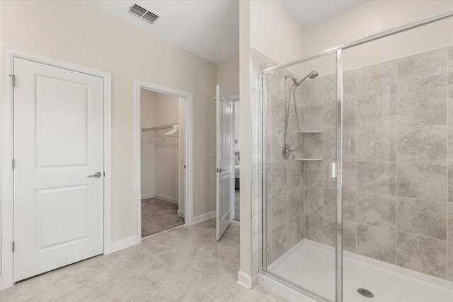 1351 Shinnecock Hills Dr, Davenport, FL 33896 - full bathroom with a shower stall, a walk in closet, and tile patterned floors