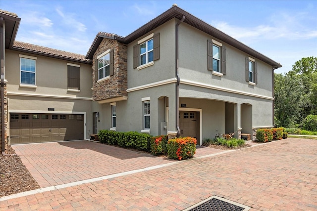 1351 Shinnecock Hills Dr, Davenport, FL 33896 - townhome / multi-family property with a garage, stucco siding, decorative driveway, and a tiled roof