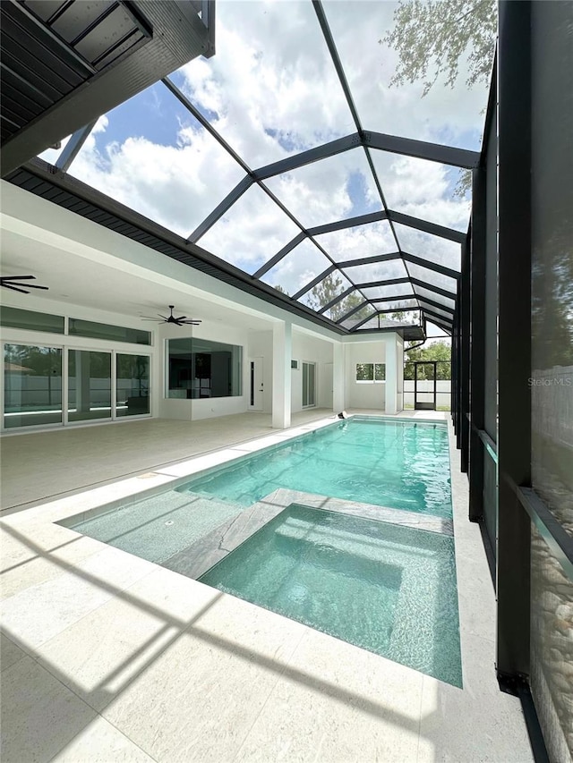 9 Edison Ln, Palm Coast, FL 32164 - view of pool with ceiling fan, a patio area, a pool with connected hot tub, and glass enclosure