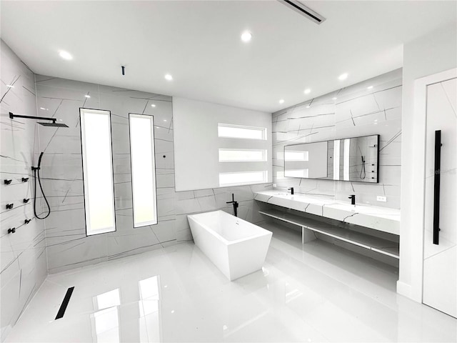 9 Edison Ln, Palm Coast, FL 32164 - full bathroom featuring tile walls, double vanity, a walk in shower, a soaking tub, and recessed lighting