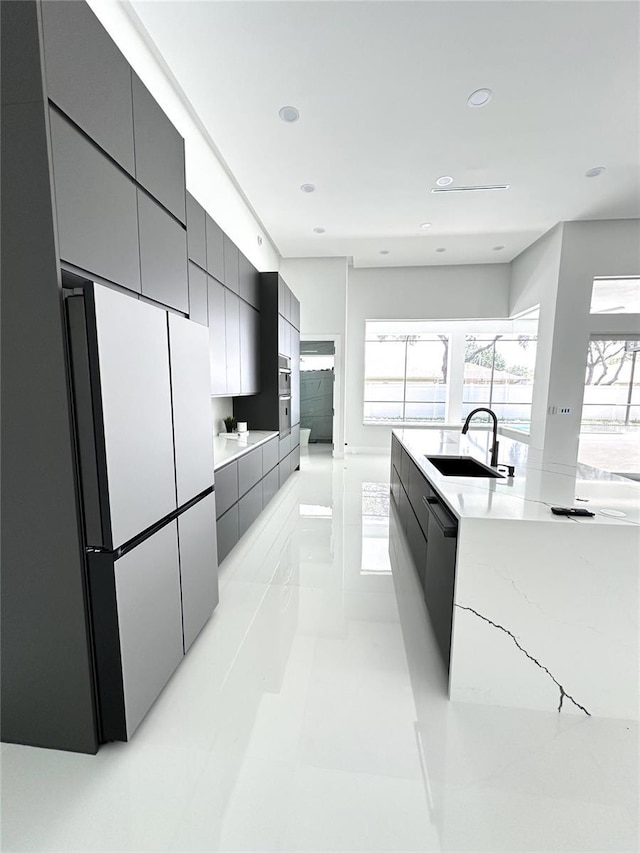 9 Edison Ln, Palm Coast, FL 32164 - kitchen with modern cabinets, freestanding refrigerator, healthy amount of natural light, and recessed lighting