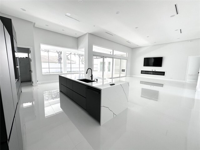 9 Edison Ln, Palm Coast, FL 32164 - kitchen with modern cabinets, plenty of natural light, light countertops, and dark cabinets