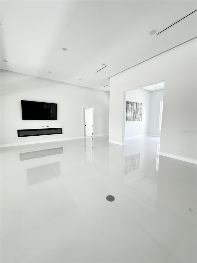 9 Edison Ln, Palm Coast, FL 32164 - unfurnished living room with tile patterned flooring and baseboards