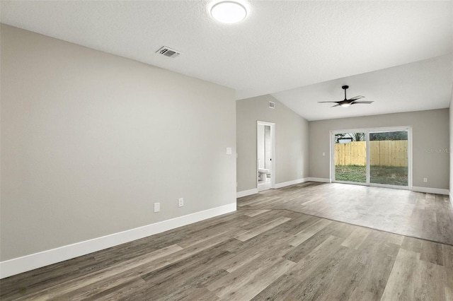 1850 N St, Longwood, FL 32750 - unfurnished room with wood finished floors, lofted ceiling, ceiling fan, and a textured ceiling