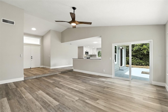 1850 N St, Longwood, FL 32750 - unfurnished living room featuring lofted ceiling, light wood-type flooring, and a ceiling fan