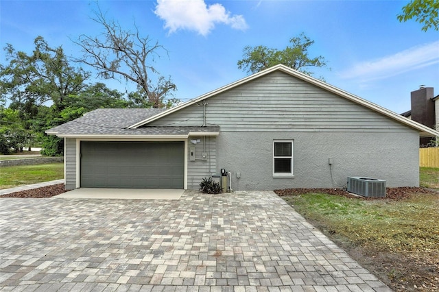 1850 N St, Longwood, FL 32750 - view of side of home with a garage, decorative driveway, stucco siding, and roof with shingles