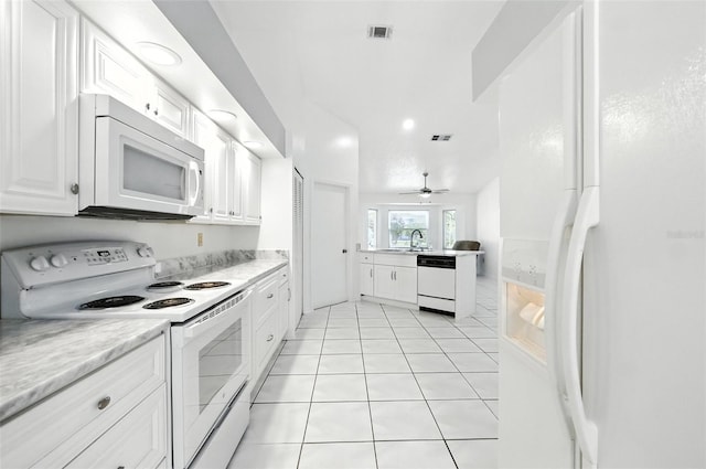 22 Bradford Ct, Kissimmee, FL 34758 - kitchen featuring white appliances, a peninsula, white cabinets, light countertops, and light tile patterned floors