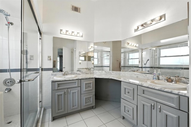 22 Bradford Ct, Kissimmee, FL 34758 - full bath featuring double vanity, a stall shower, and tile patterned flooring