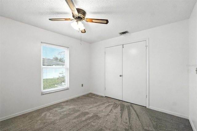 22 Bradford Ct, Kissimmee, FL 34758 - unfurnished bedroom featuring carpet, a textured ceiling, a closet, and a ceiling fan