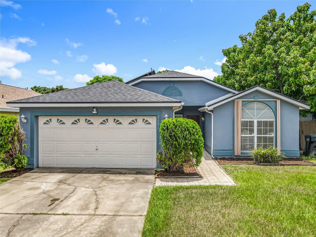 1131 Tyler Lake Cir, Orlando, FL 32839 - ranch-style home featuring driveway, a front lawn, a garage, stucco siding, and roof with shingles