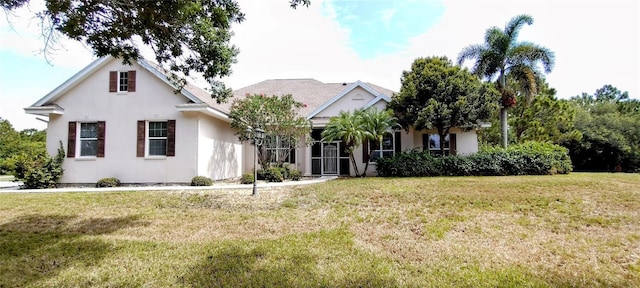 5595 Schefflera, Grant, FL 32949 - view of front facade with a front yard and stucco siding