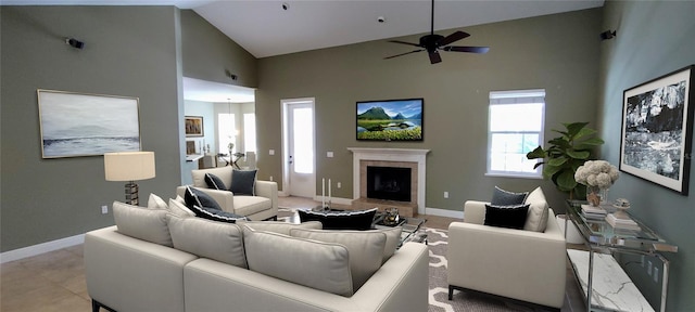 5595 Schefflera, Grant, FL 32949 - living room featuring a tiled fireplace, ceiling fan, and high vaulted ceiling