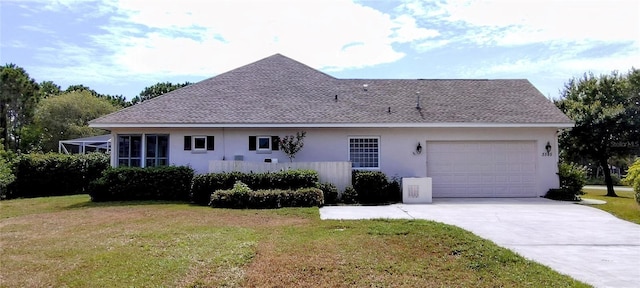 5595 Schefflera, Grant, FL 32949 - view of property exterior featuring stucco siding, an attached garage, a lawn, driveway, and roof with shingles