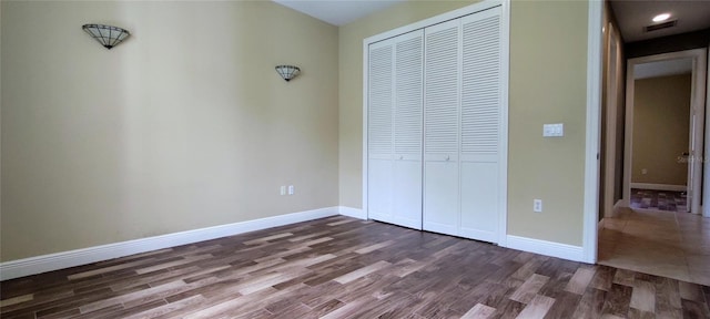 5595 Schefflera, Grant, FL 32949 - unfurnished bedroom featuring a closet, dark wood finished floors, and recessed lighting