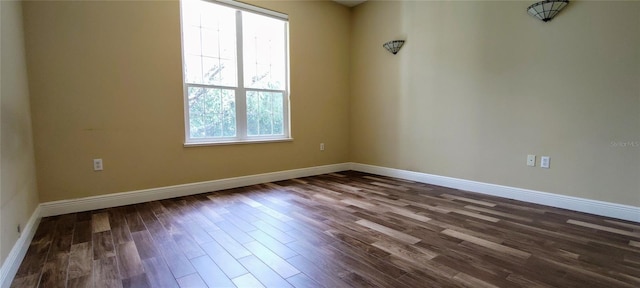 5595 Schefflera, Grant, FL 32949 - unfurnished room with dark wood-style floors and baseboards
