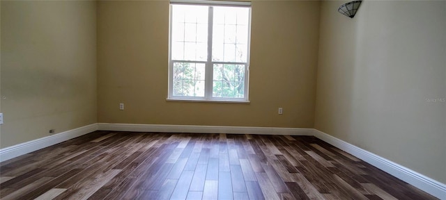 5595 Schefflera, Grant, FL 32949 - spare room with baseboards and dark wood-style flooring