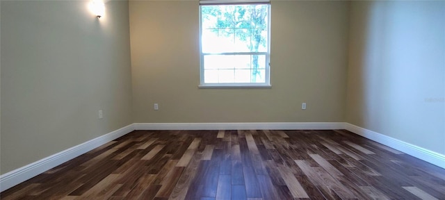 5595 Schefflera, Grant, FL 32949 - spare room with dark wood-style flooring and baseboards